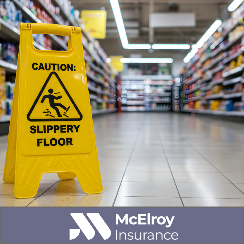 Yellow slippery floor warning sign displayed in a retail store aisle, highlighting a common premises liability risk that can lead to customer injury claims and business liability exposure.
