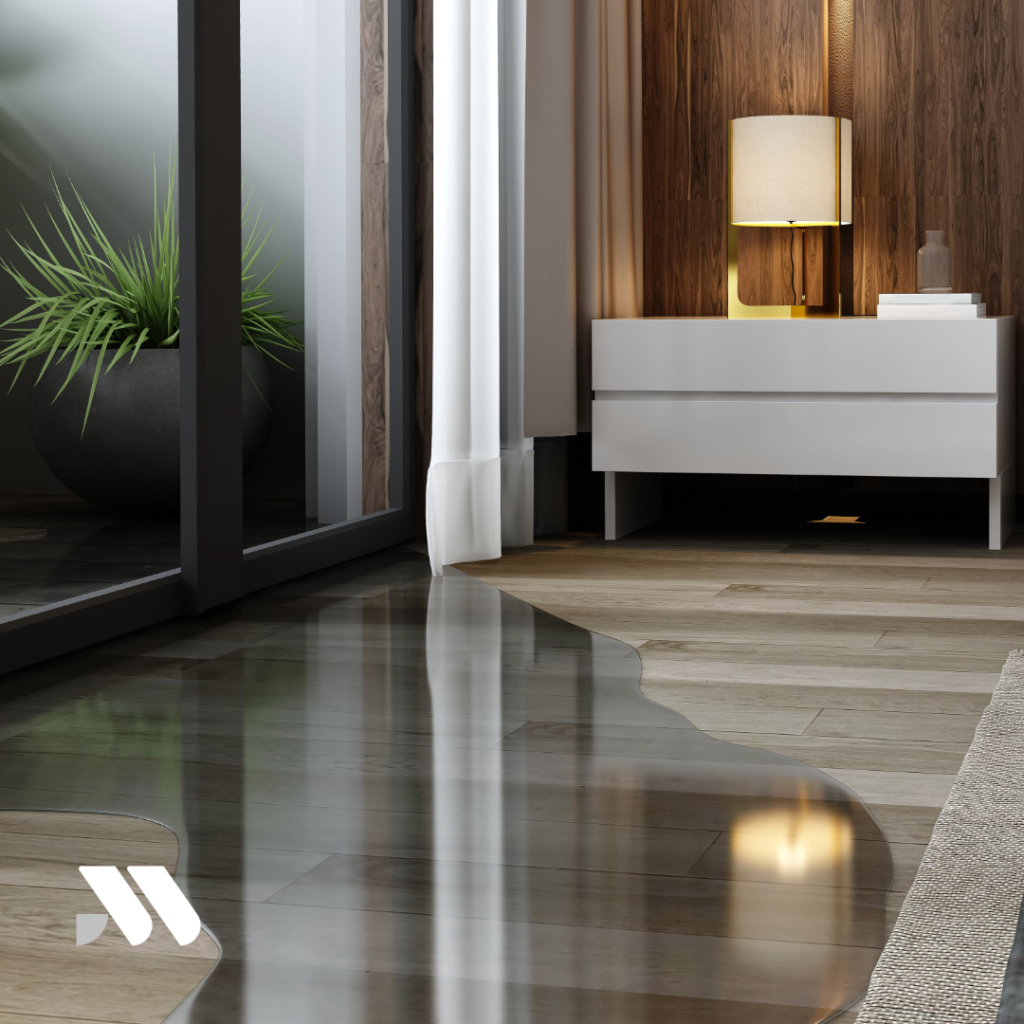 Water spreading across hardwood flooring inside a home after a plumbing leak, illustrating a common homeowners insurance water damage claim scenario.
