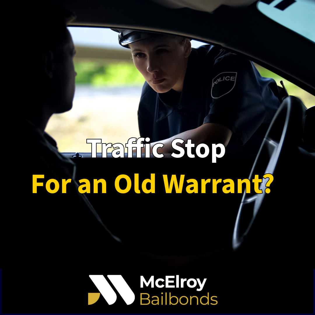 Police officer conducting a traffic stop while checking driver's information for outstanding warrants through a law enforcement database.