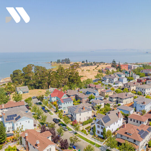Aerial view of a residential neighborhood in Hercules, California overlooking the San Pablo Bay shoreline and waterfront area.