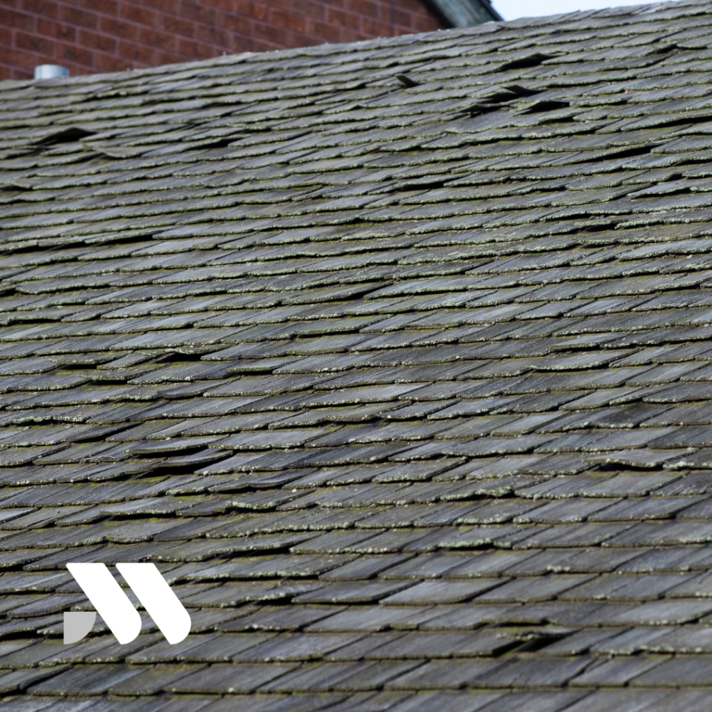 Aging residential roof with worn and uneven shingles showing visible signs of deterioration that may impact homeowners insurance eligibility and coverage.