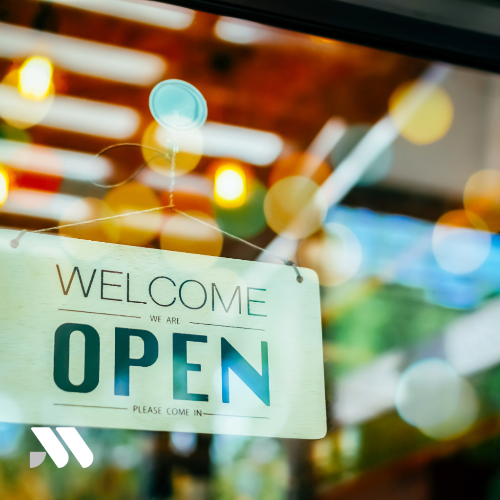 "Open" sign displayed in the front window of a newly opened restaurant or retail business, representing the launch of a new business and the importance of securing insurance before opening day.